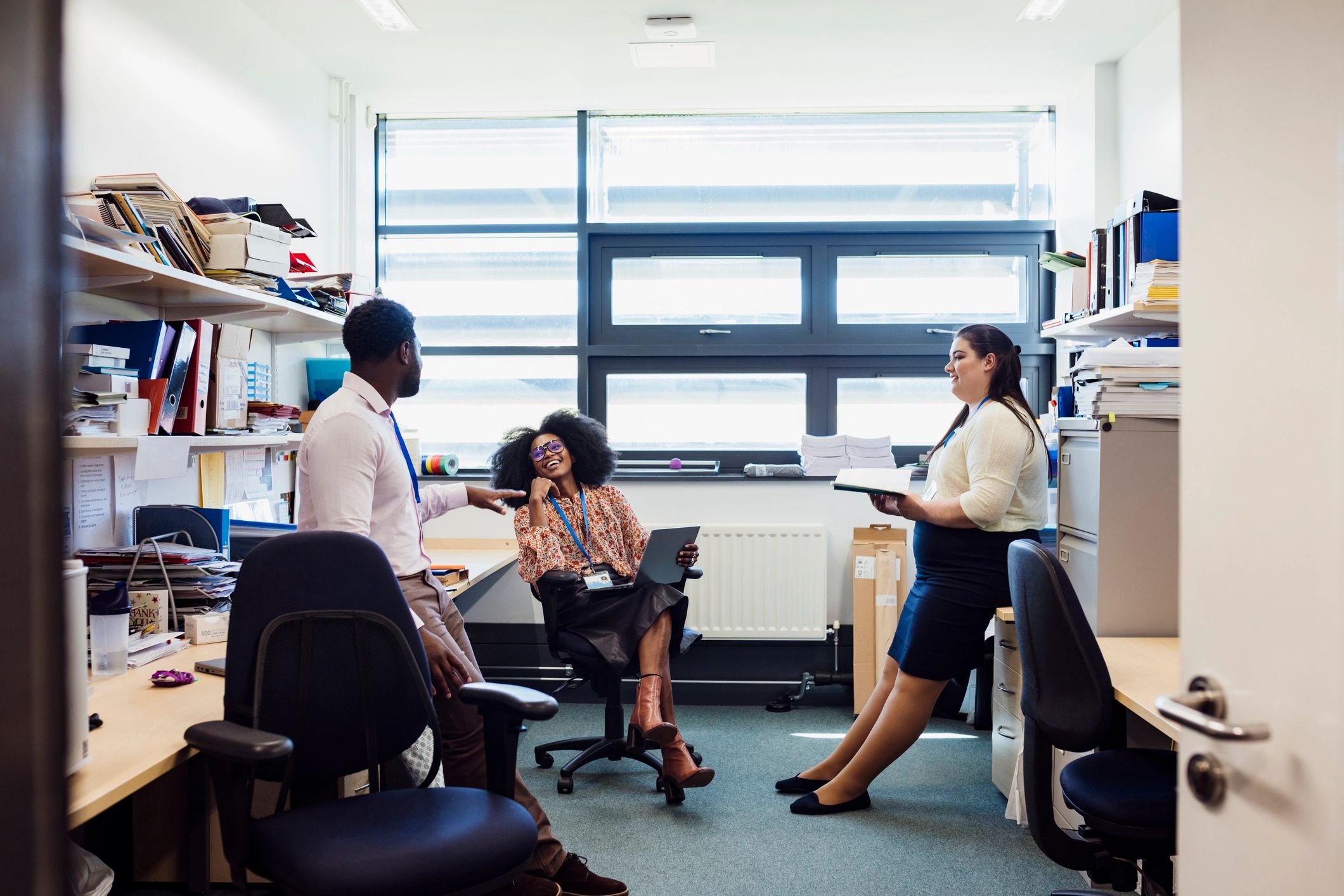 Administrative professionals collaborating in an office